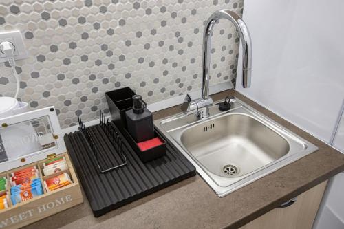 a kitchen sink with a faucet on a counter at Theatre Square Apartments in Novi Sad