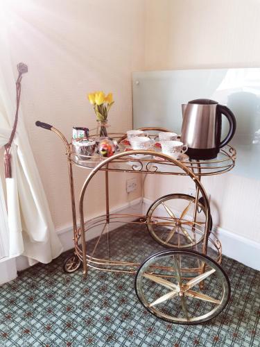 a metal cart with a tea kettle on it at Victoria Hotel in Blairgowrie