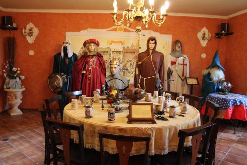 a dining room with a table with dolls on it at IL Castello dei Templari in Pietrelcina