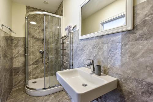 a bathroom with a sink and a shower at Auroradream in Motiejiškės