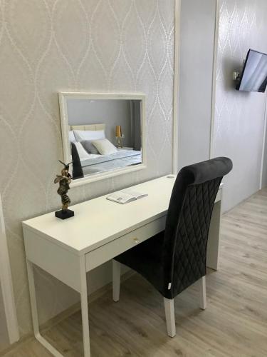 a white desk with a chair and a mirror at Apartament Mickiewicza - PKP Station in Przemyśl