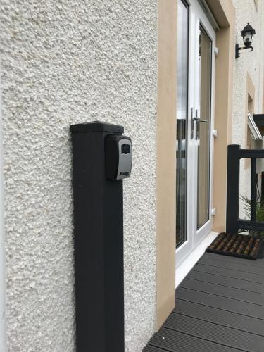 a black mailbox on the side of a building at Carrick Hills Cosy Croft STL SA-00137-F in Dunure