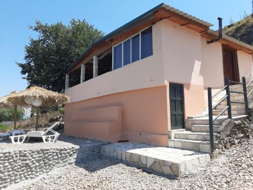 a house with a staircase leading up to it at Skadar Lake House Virpazar in Virpazar