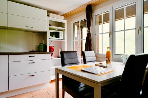 a kitchen and dining room with a table and chairs at Mönch Amazing Apartment Grindelwald in Grindelwald