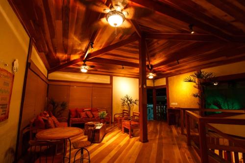 a living room with a table and a couch at Estrada Real Palace Hotel in Brumadinho