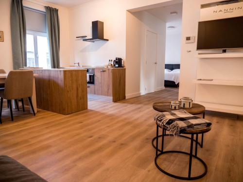 a living room with a table and a kitchen at Maison Willem Tell in Ghent
