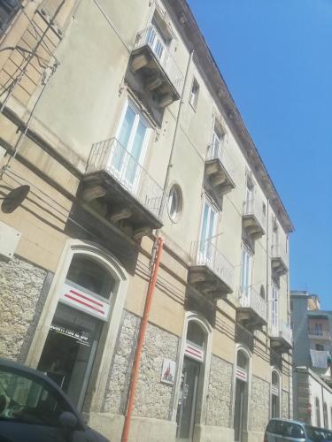 a building with balconies on the side of it at Sapore di Sale - Sicily Rooms in Siracusa
