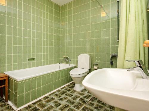 a bathroom with a tub and a toilet and a sink at Holiday home Varde II in Varde