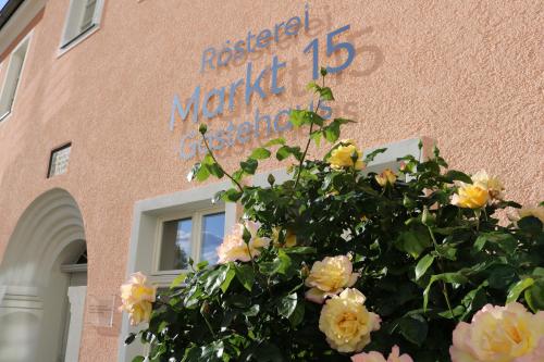 una señal en el lado de un edificio con flores en Markt 15 Gästehaus, en Senftenberg