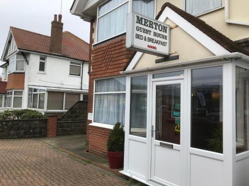 a store with a white door on a building at Merton House in Worthing
