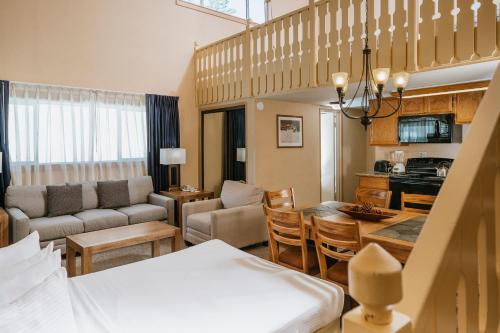 a living room with a kitchen and a dining room at Mammoth Mountain Inn in Mammoth Lakes