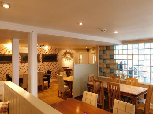 a dining room and kitchen with a table and chairs at The Nags Head in Norwich