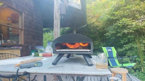 a grill sitting on a table with a table at Nettles Farm in Lummi Island