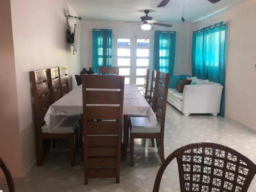a dining room with a table and chairs and a couch at La Gaviota B3 in Juan Dolio