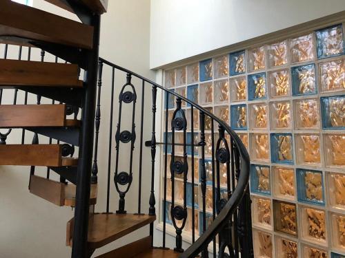 a spiral staircase with a glass block wall at The Nags Head in Norwich