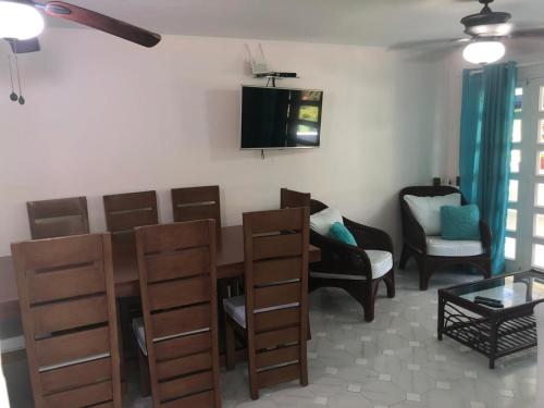 a living room with a dining room table and chairs at La Gaviota A3 in Juan Dolio