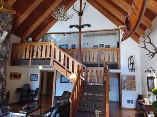 a living room filled with furniture and a staircase at Nisqually Lodge in Ashford