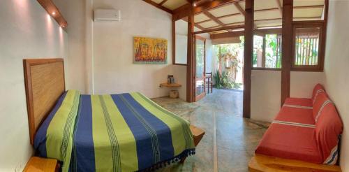 a bedroom with a bed and two chairs in it at Galería Suites San Pancho in San Francisco