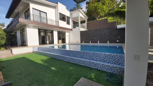 a house with a swimming pool in front of it at CASA EL MIRADOR in Anapoima