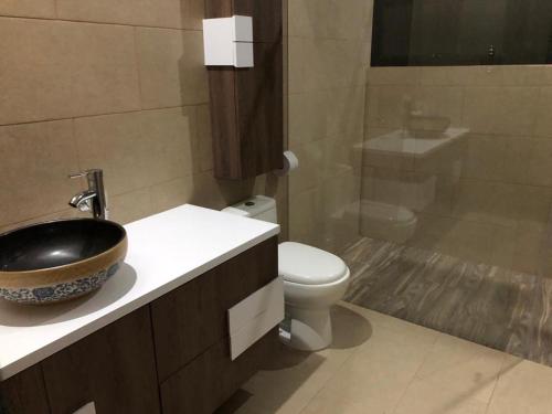 a bathroom with a sink and a toilet at CASA EL MIRADOR in Anapoima