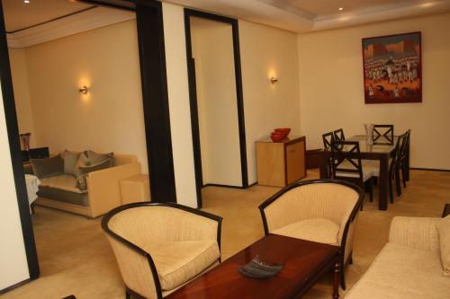 a living room filled with furniture and a large window at Atlas Orient in Oujda