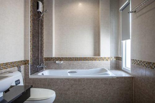a bathroom with a tub and a toilet and a sink at Poonsiri Private Pool Villa Aonang in Ao Nang Beach