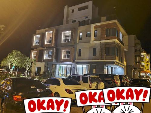 a parking lot with cars parked in front of a building at The Lin Inn in Kenting