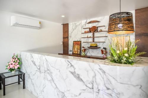 a white marble counter in a room with a table at Dee Homestay in Ban Pa Khlok