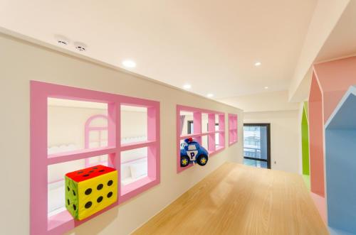 a childs room with a toy motorcycle on the wall at The Lin Inn in Kenting