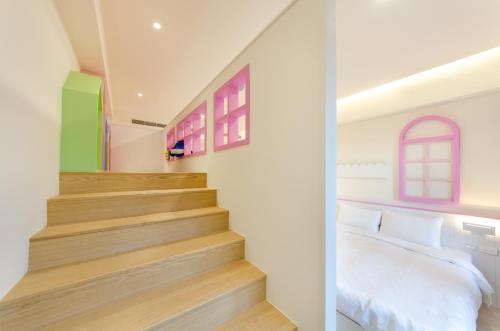 a bedroom with a bed and a staircase at The Lin Inn in Kenting