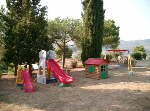 a playground with a slide and a play house at Residence Fiorenzo in Capoliveri
