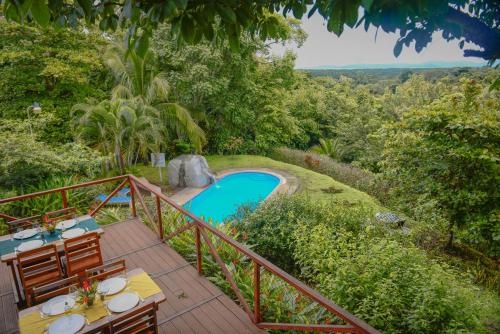 a view of a pool from the deck of a villa at Hotel Cerro Lodge in Tarcoles