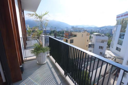 a balcony with two potted plants on a building at MENTO HOTEL QUY NHƠN in Quy Nhon
