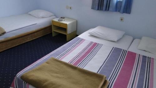 a hotel room with two beds and a table at Sunrise Hotel in Antalya