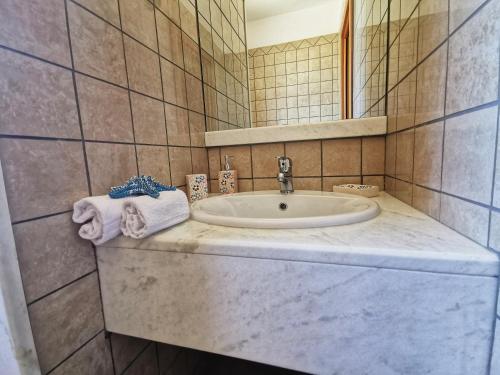 a bathroom with a sink and a mirror at Villa Arenile - Seaside - Swimmingpool- Private access to Sea - waterfront - Fontane Bianche - Siracusa in Fontane Bianche