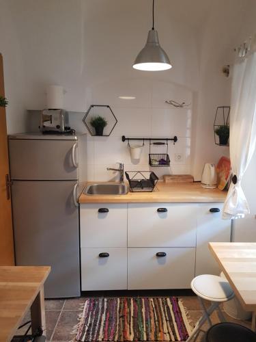 a kitchen with a sink and a refrigerator at Come to M2 in Zagreb