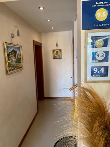 a hallway with a room with a sign on the wall at Family Hotel Saint Nikola and Free parking in Nesebar
