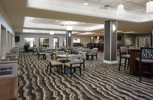 a waiting room with tables and chairs in a hospital at Staybridge Suites Orlando South by IHG in Orlando