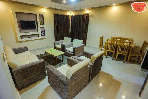 a living room with couches and a dining room at Maamoura Armed Forces Apartments in Alexandria