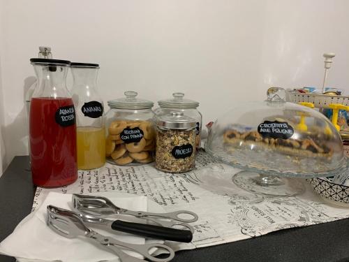 a table with jars of food and a pair of scissors at B&b Le Larie in Collepardo