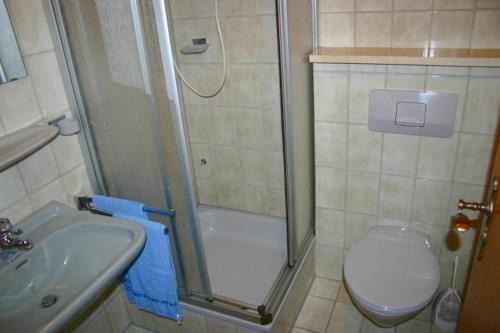 a bathroom with a shower and a toilet and a sink at Sunrise Hotel in Antalya