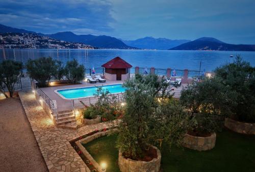 a swimming pool with a view of the water at Apartments Maxi Katić in Herceg-Novi