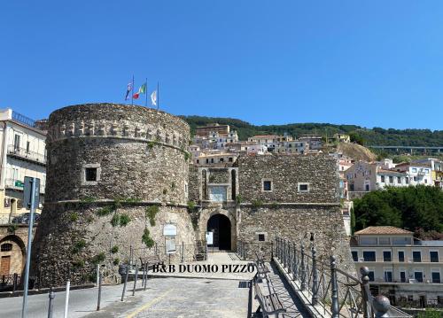 a gate to a castle in a city at B&B Duomo Pizzo ApartHotel in Pizzo