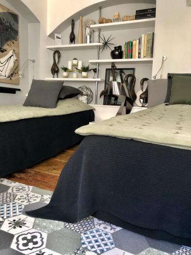 a bedroom with two beds and a rug at Quai 17 Maison d'hôtes in Strasbourg
