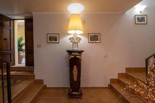 a hallway with a clock and a lamp on a wall at Vico d'Ercole in Fondi