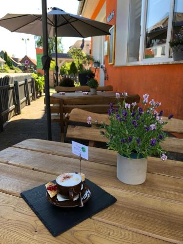 a table with a plate of food and a bowl of food at Pension Mühlhahn in Schierke