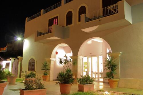 a large white building with a large window at Hotel O'scià in Lampedusa