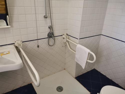 a bathroom with a shower with a sink and a toilet at Hotel Nazionale in Bolsena