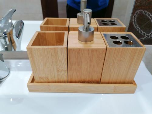a wooden soap dispenser sitting on top of a sink at Agave in Reggio Calabria