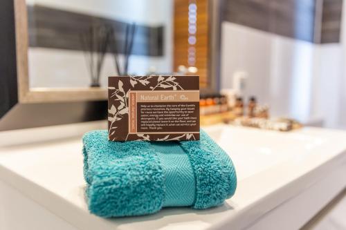 a box on top of a pile of towels on a counter at Talisman Hotel & Restaurant in Katikati